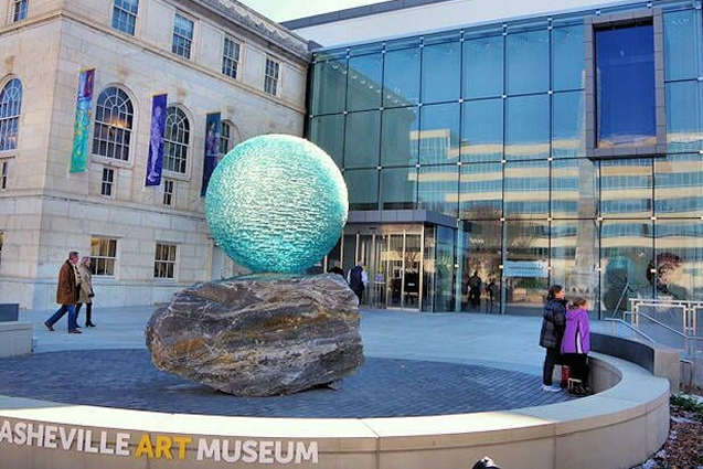 Large blue Globe on Rock in Round Ring outside of Arts building