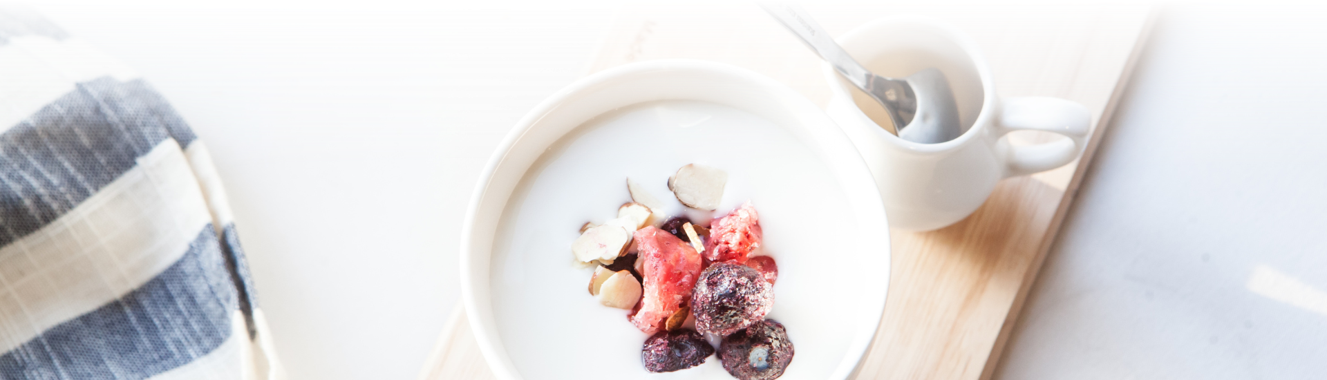 Berries placed in yogurt set on a wooden setting